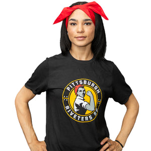 A person wearing a black T-shirt with 'Pittsburgh Riveters' logo and a red bandana tied around the head.